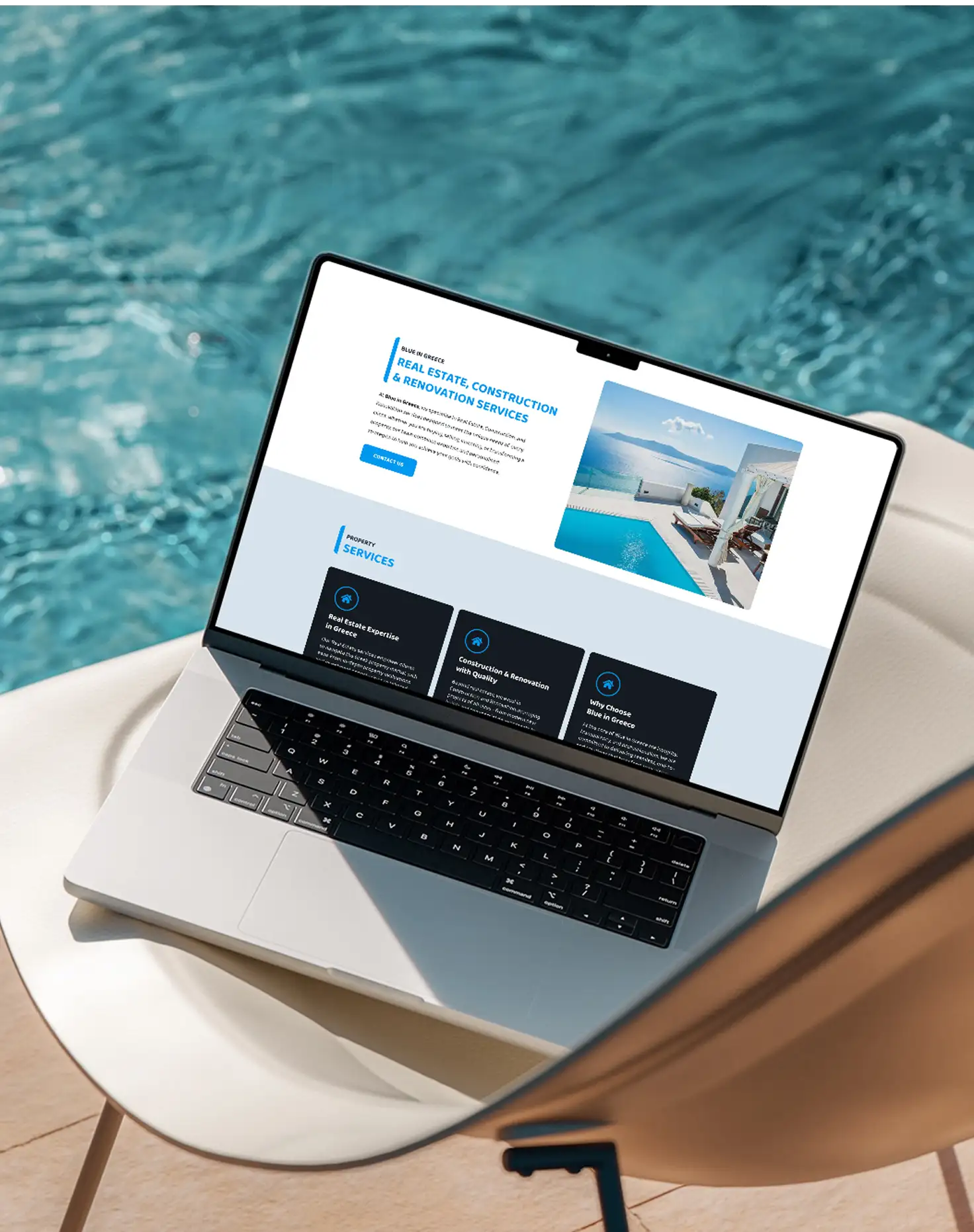 The Blue in Greece website on a laptop beside a swimming pool