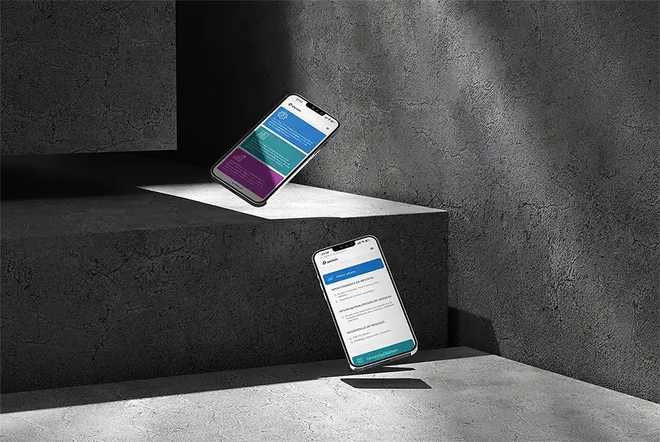 Two iPhones showing the Pactum mobile site's service cards floating in a concrete interior